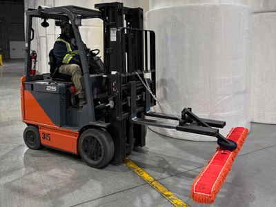 Forklift Sweeper Attachment In Warehouse